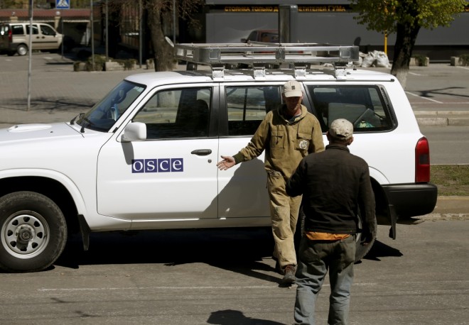 municipal-workers-take-photo-organization-security-cooperation-europe-osce-car-near-seized