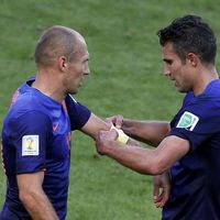 Robben of the Netherlands receives the captain's armband from Robin van Persie during their 2014 World Cup Group B soccer match against Australia at the Beira Rio stadium in Porto Alegre